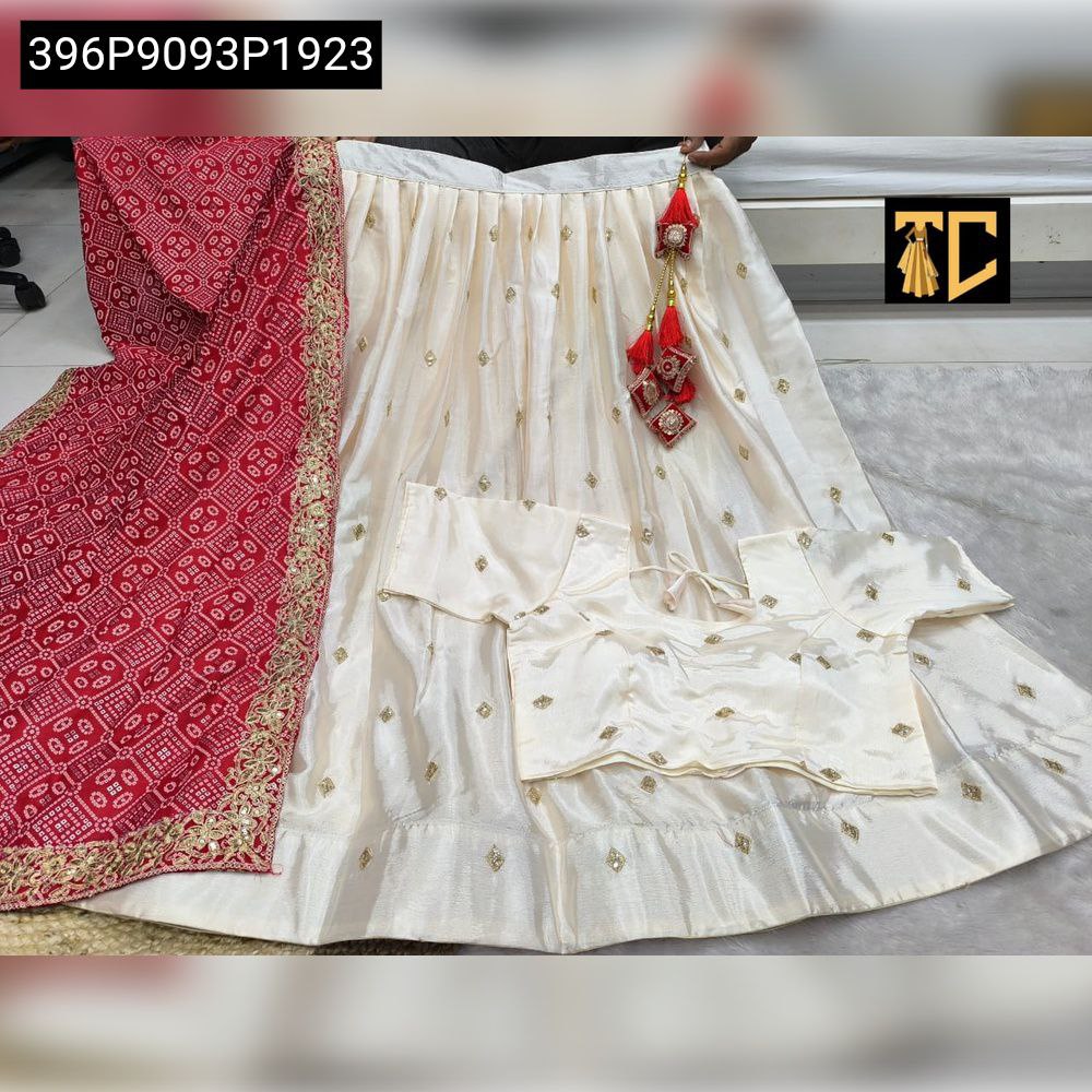 TRENDBUY Chinnon Silk Lehenga Set - Complete flat lay of embroidered lehenga, matching blouse, and bandhani print dupatta.