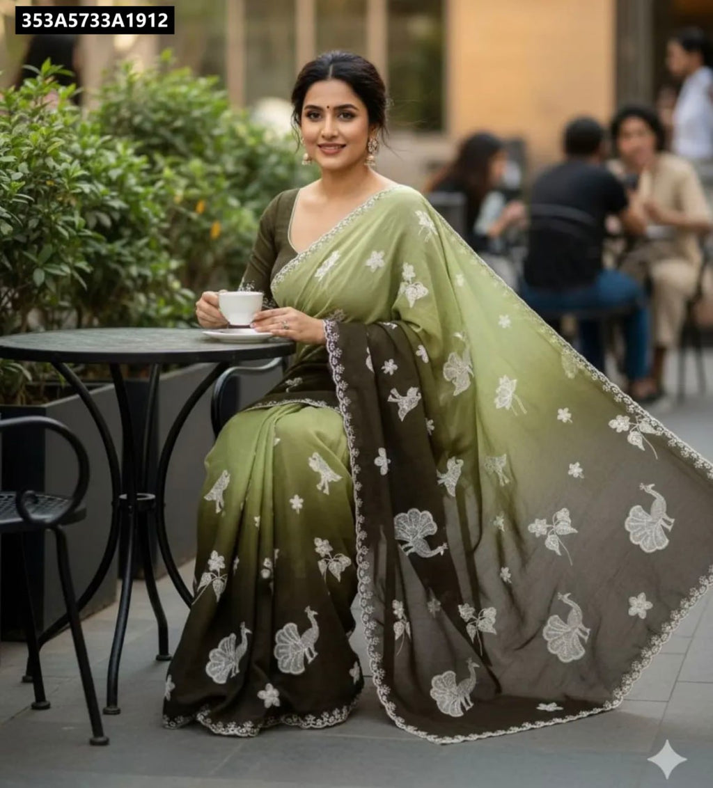 Model in TRENDBUY Emerald and Olive Ombre Chinnon Silk Saree with White Peacock and Floral Embroidery, scalloped border, sitting outdoors