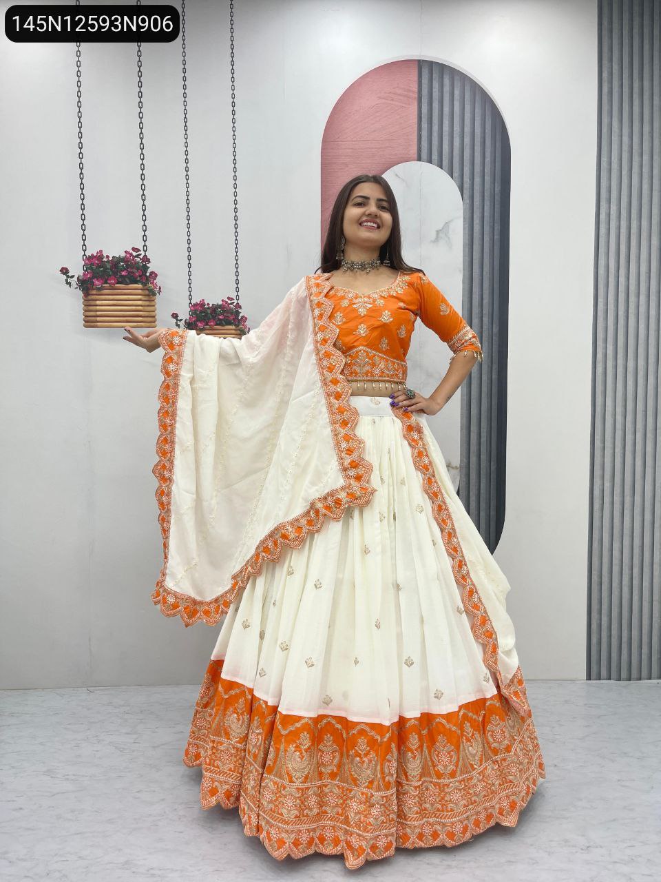 TRENDBUY model smiling, front-facing, showcasing Orange and White Chinon Lehenga Choli.