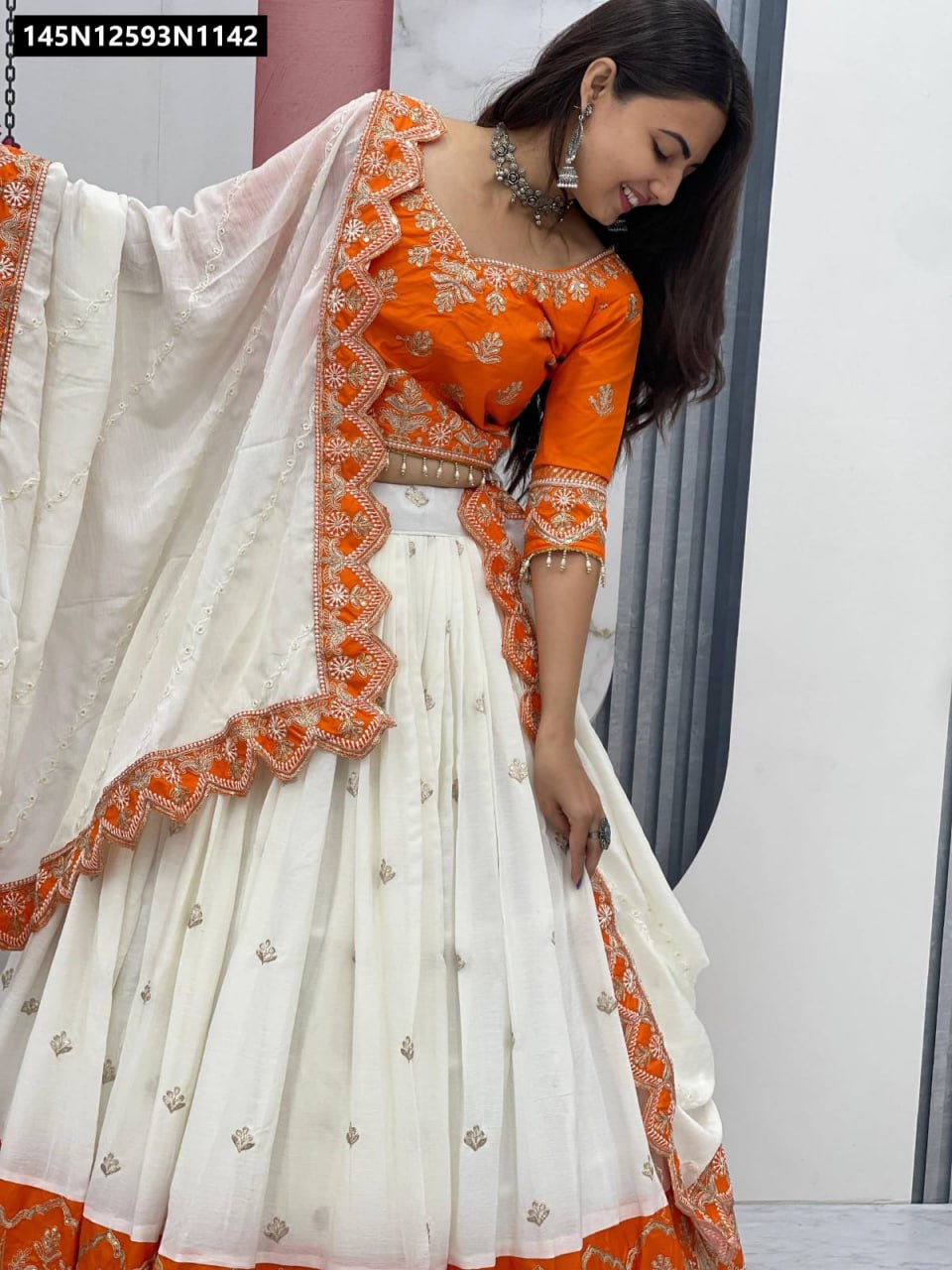 Full body mirror selfie of model wearing TRENDBUY Orange and White Chinon Lehenga, capturing the complete ethnic ensemble.