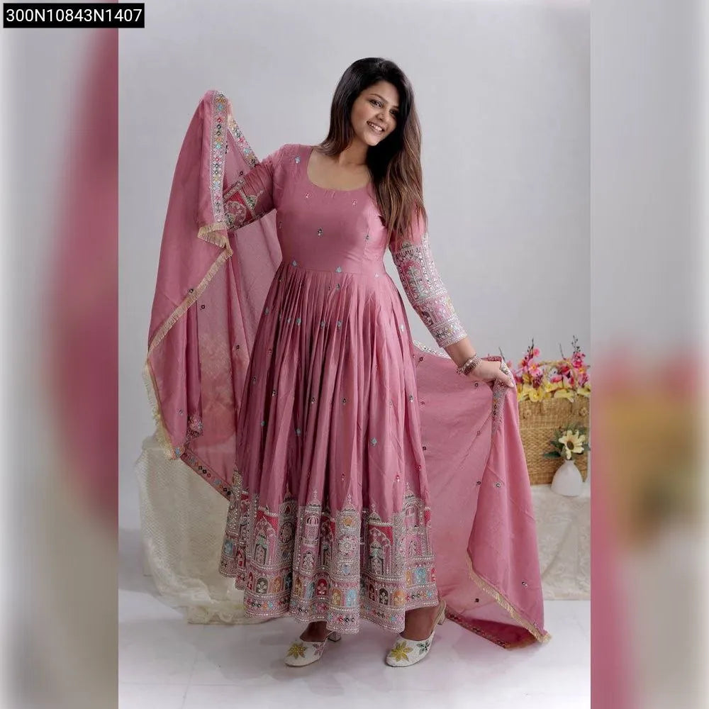 Model wearing a lavender embroidered Cinon silk gown with dupatta and pants, smiling.