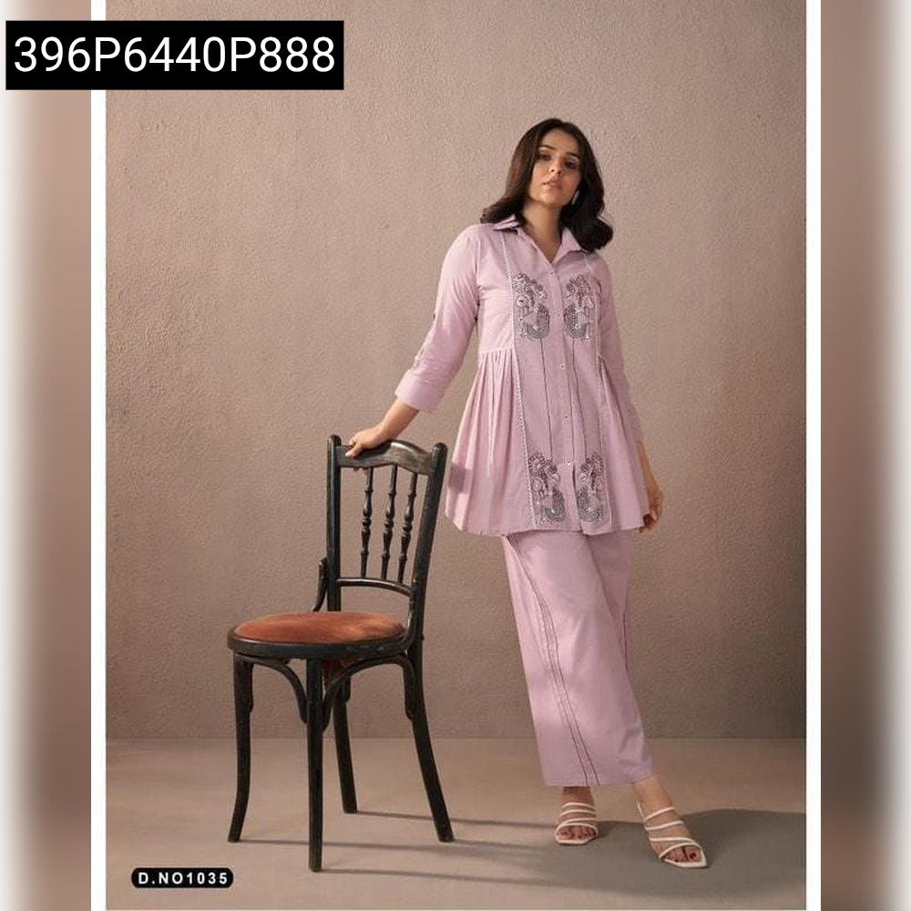 Woman posing in lavender embroidered cotton co-ord set, featuring a pleated top and straight pants.