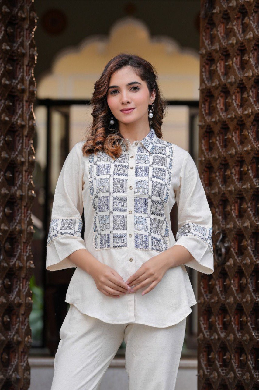 Woman in white embroidered cotton flex co-ord set, front view