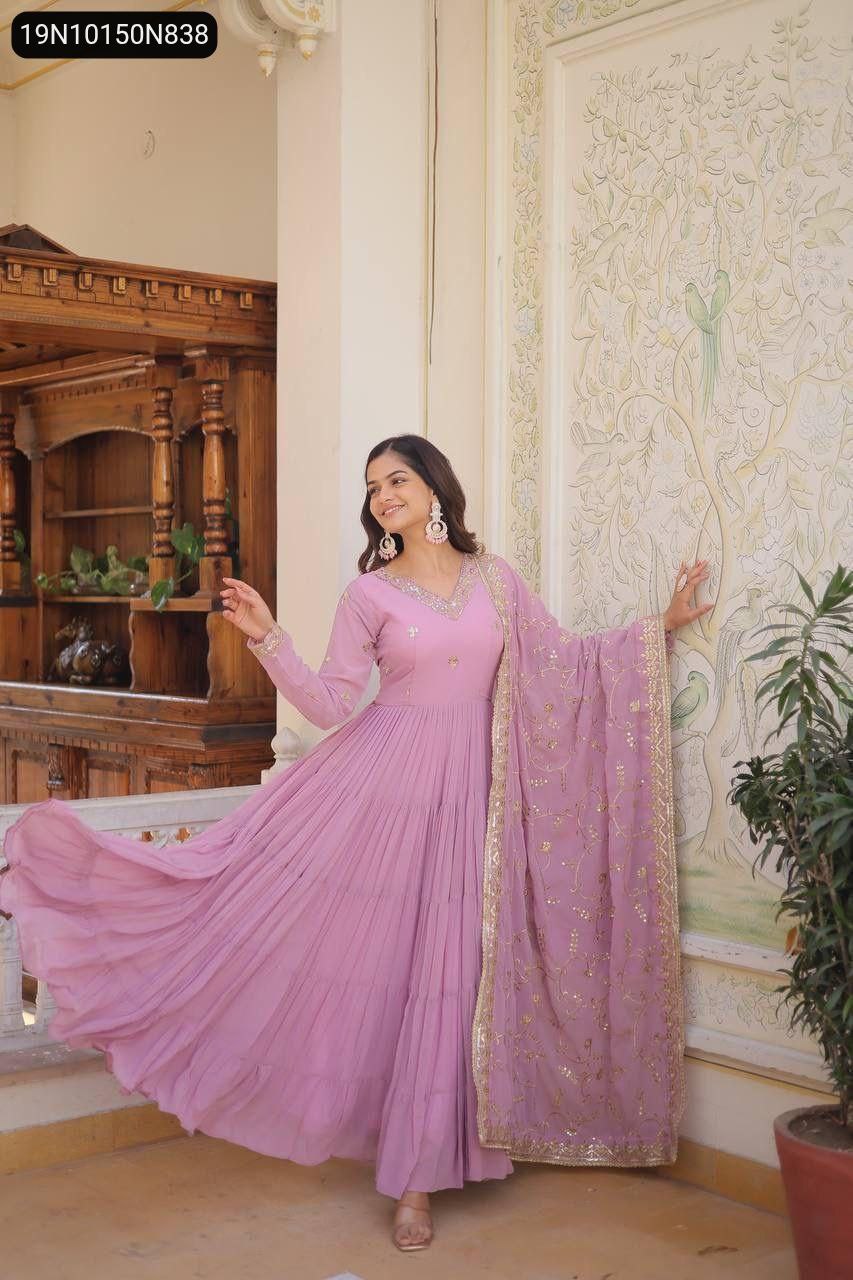 Model in lavender faux georgette gown, posing elegantly with flowing fabric.