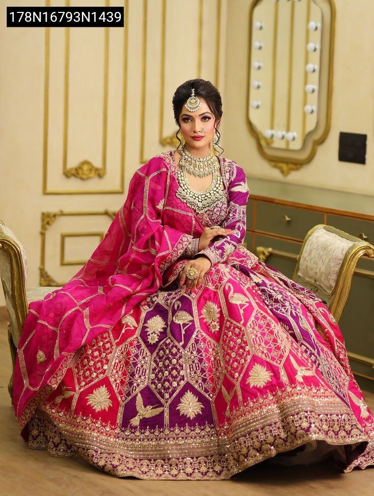 Model seated, displaying the full flair of the Fuchsia Dream embroidered Lehenga Choli