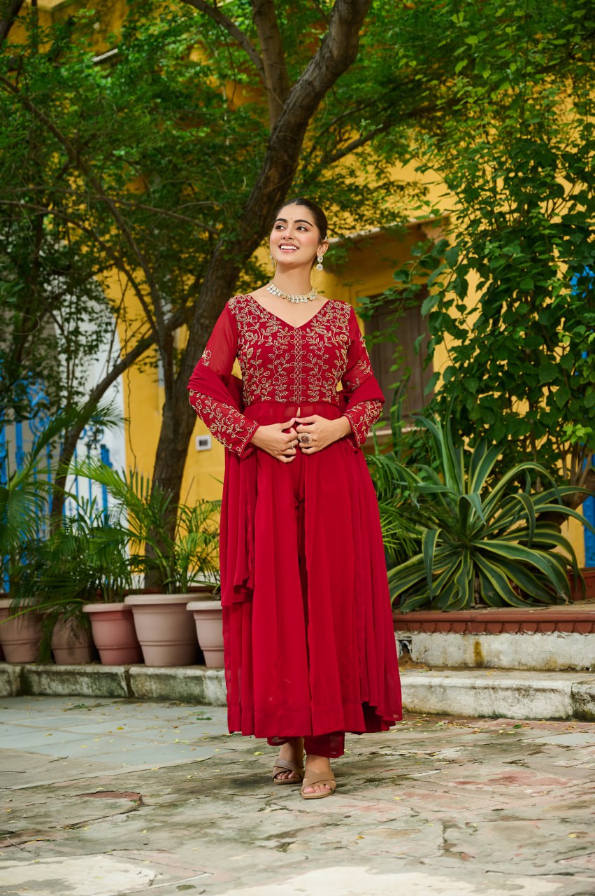 Woman model elegantly posing in a maroon Faux Blooming embroidered kurti set with full sleeves and V-neck.