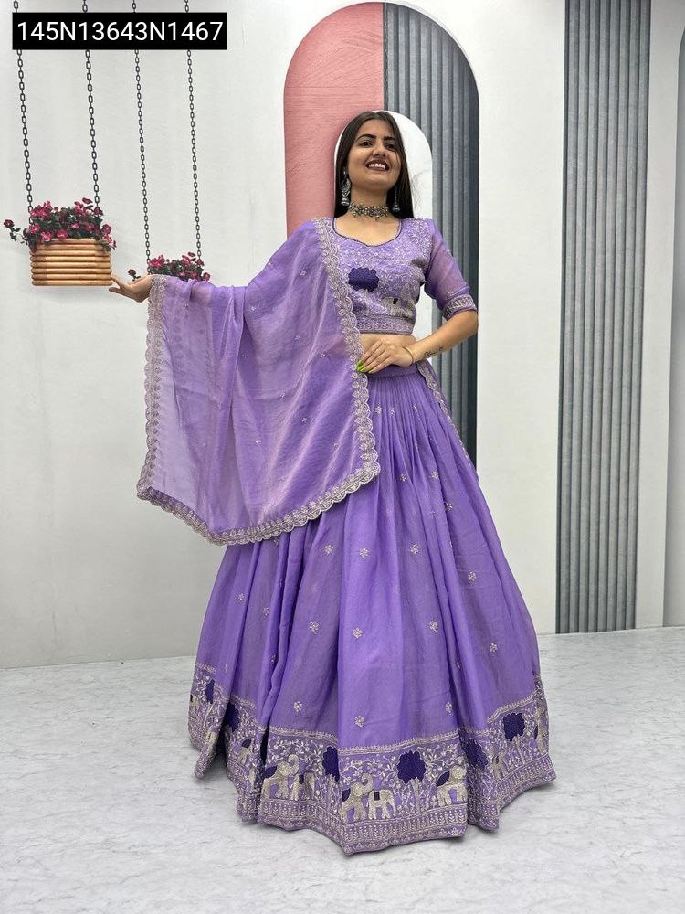 Full shot of model wearing Lavender moss shimar embroidered lehenga choli and dupatta, front view.