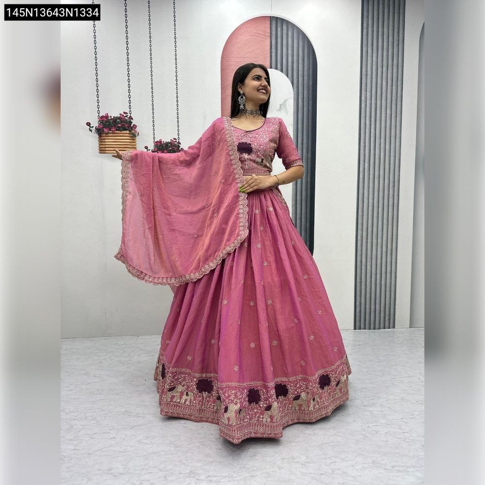 Woman posing in a pink embroidered moss shimmer lehenga choli, full body front view.