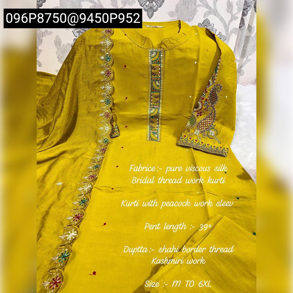 Vibrant Mustard Yellow Muslin Silk Kurti Set with intricate embroidery and sequin work, displayed on a flat surface.