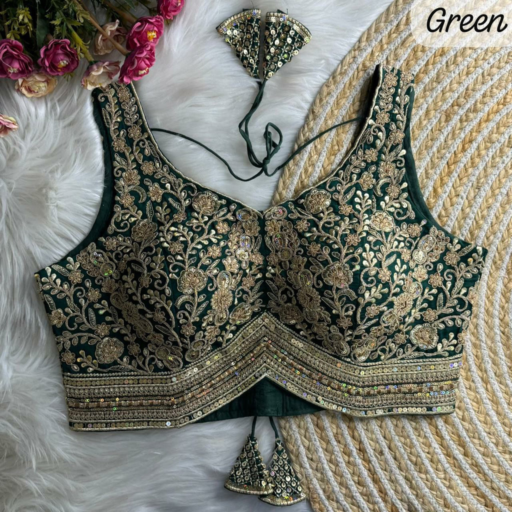 Close-up of intricate gold Zari and sequence embroidery on soft silk fabric
