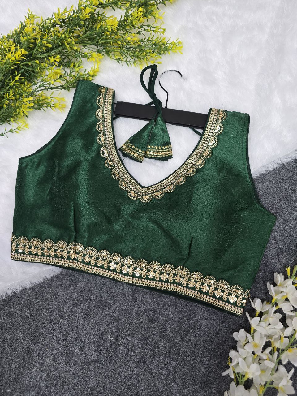 TRENDBUY Emerald Green Embroidered Party Wear Blouse for Women, sleeveless, with golden sequin work and V-neck.