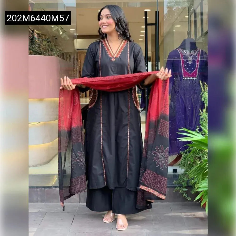 Model wearing black cotton suit set with red printed malmal dupatta, full body front view, smiling.