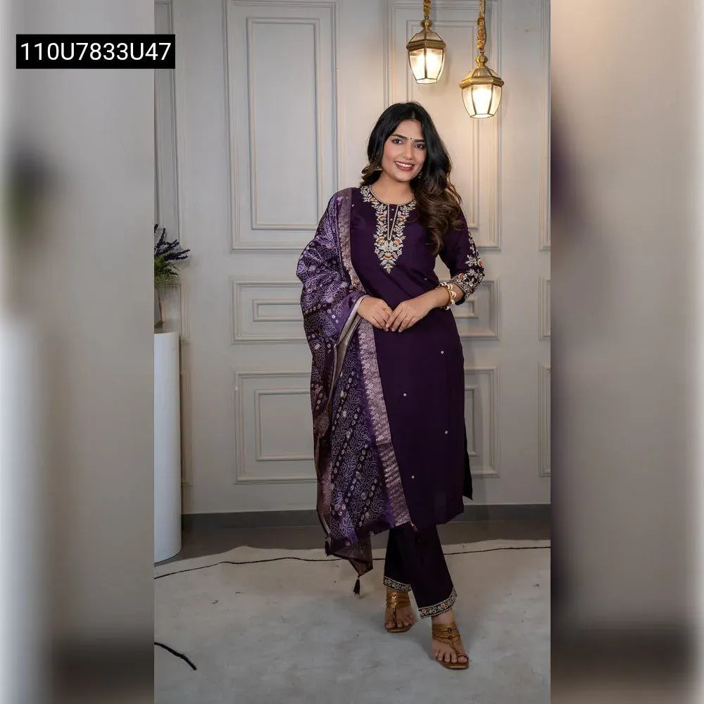 Full shot of a smiling model wearing a dark purple embroidered Roman silk kurti pant dupatta set, front facing, perfect for festive occasions.