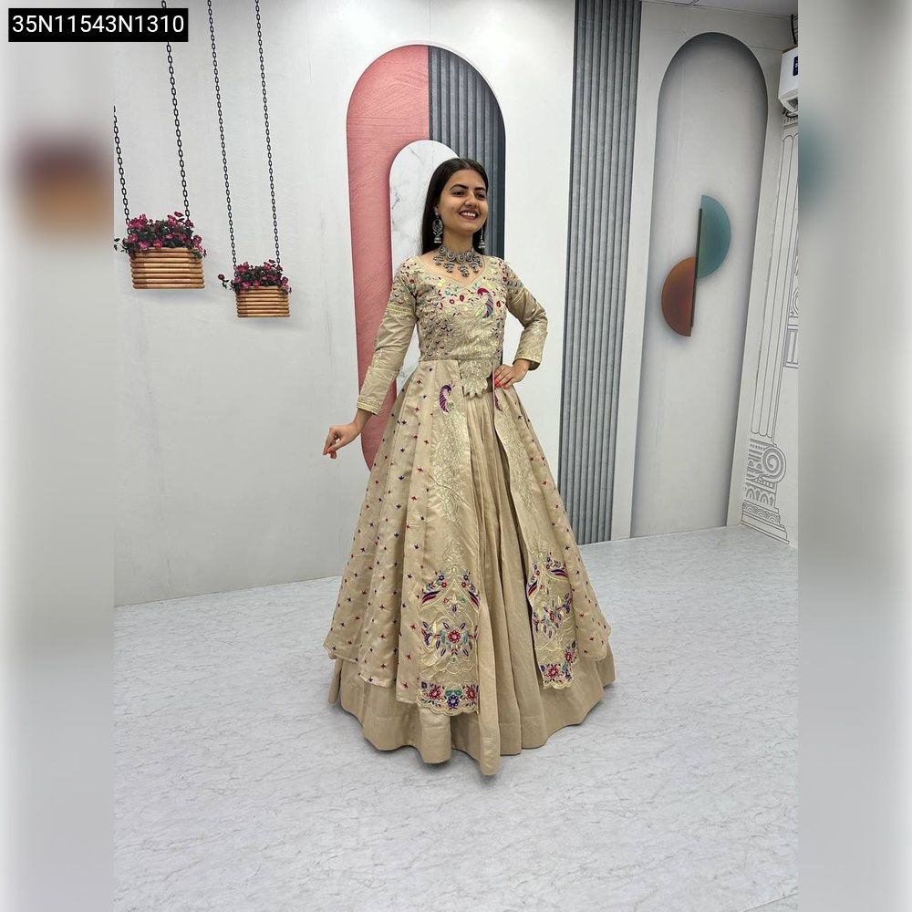 Woman in Champagne Beige Embroidered Vichitra Silk Lehenga posing front-facing, smiling, showcasing the full dress and detailed thread and sequence work.