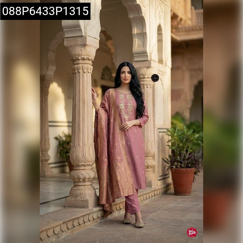 Full shot of a model elegantly posing in a Dusty Pink Embroidered Viscose Chanderi Kurti Set, showcasing the full ensemble and opulent Jacquard dupatta against a traditional architectural background.