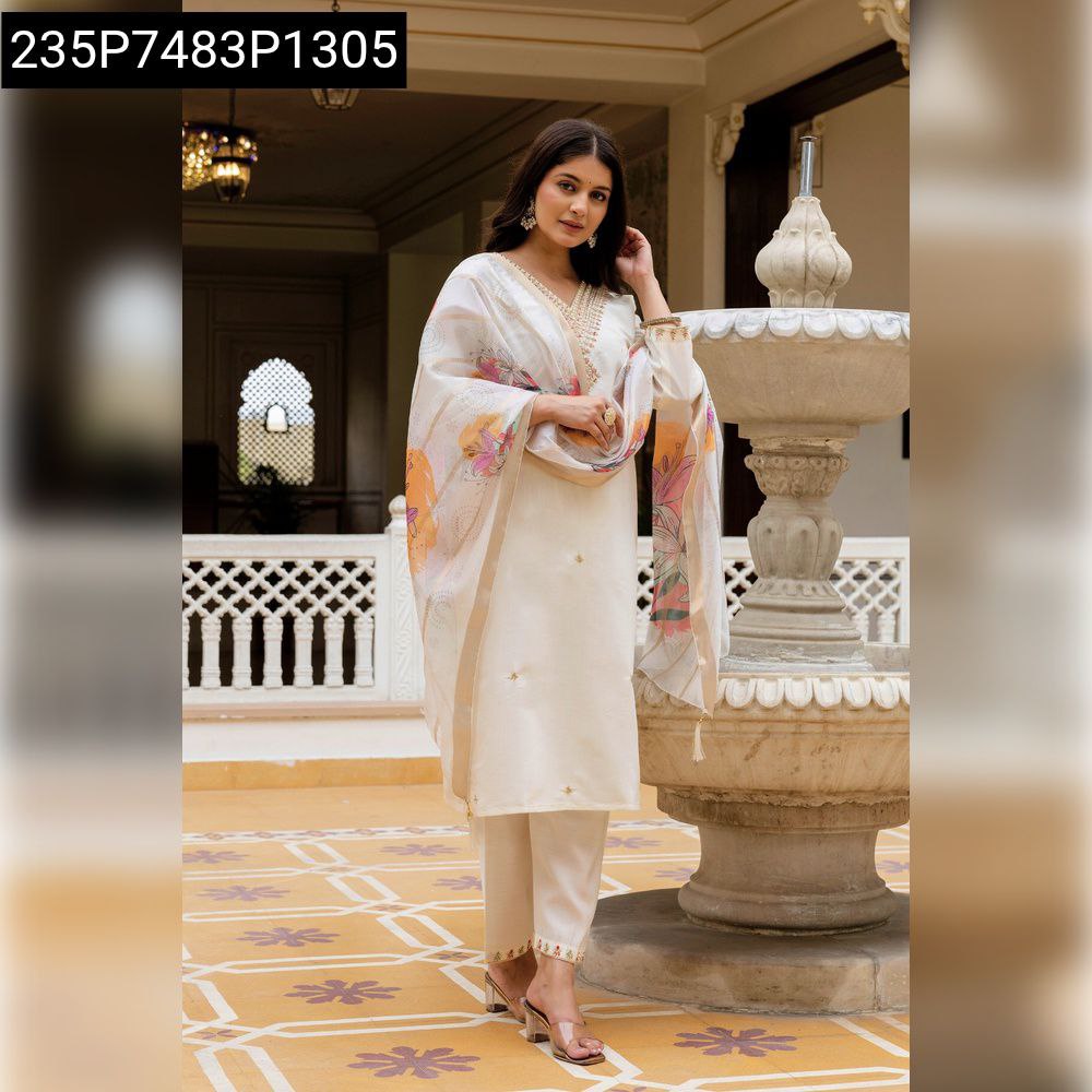 Woman in elegant cream embroidered viscose simer silk kurta pant set with floral jacquard organza dupatta, posing by a fountain.