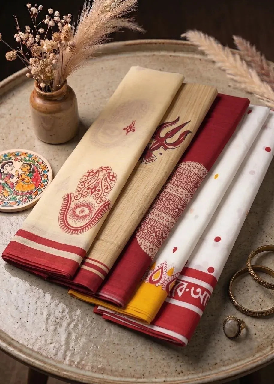 Collection of multiple colored Bagru block print cotton sarees stacked on tray