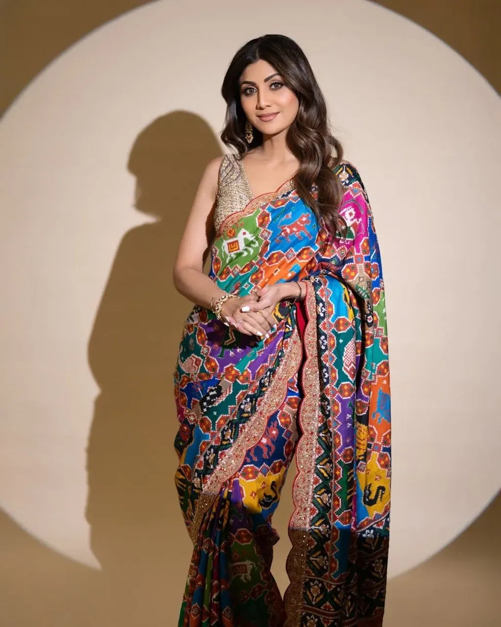 Three-quarter portrait of Shilpa Shetty showcasing a digital print Patola georgette saree with Swarovski work