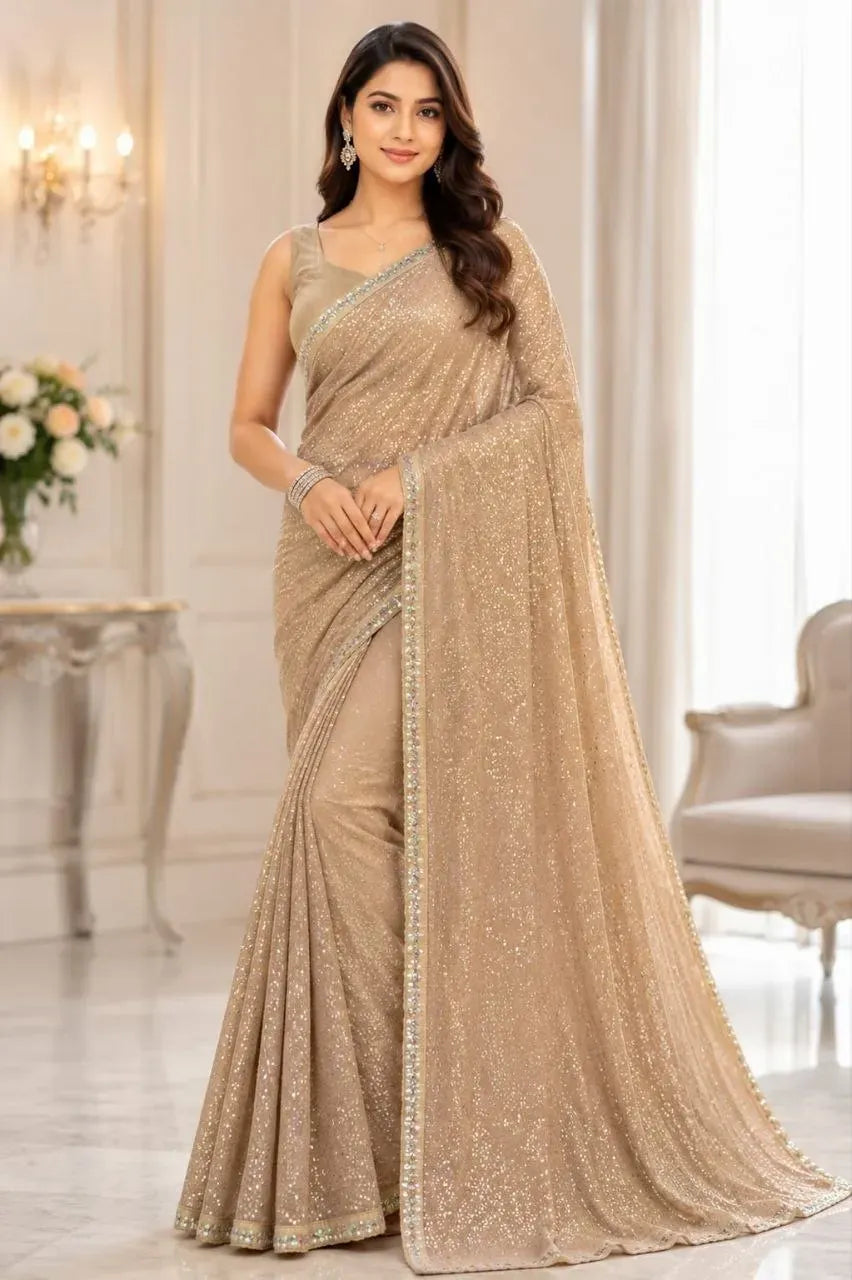 Model wearing beige georgette saree with sequence embroidery