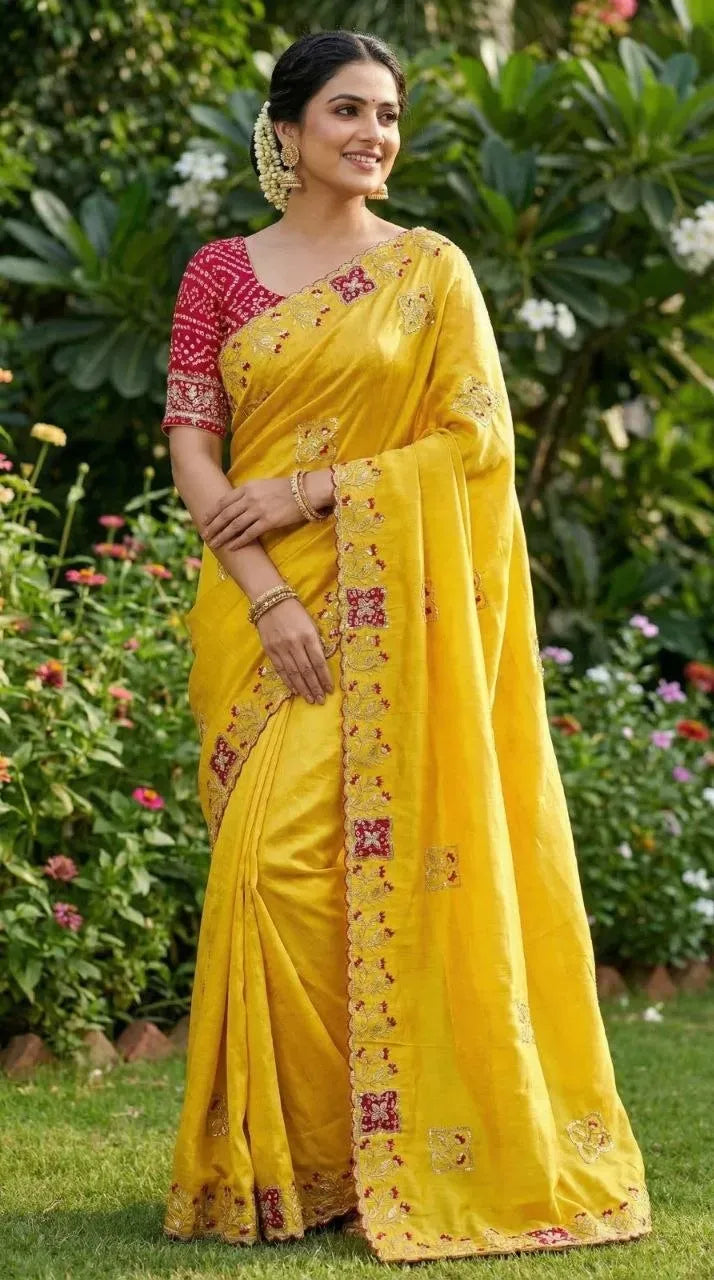 Model wearing gorgeous yellow designer saree with heavy zari work outdoors
