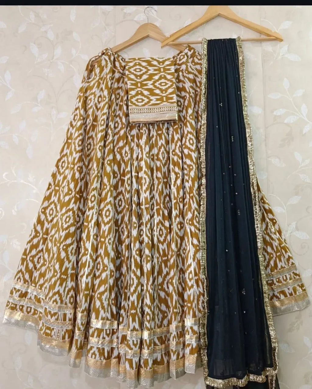 Yellow and white ikat print cotton lehenga paired with a black georgette dupatta