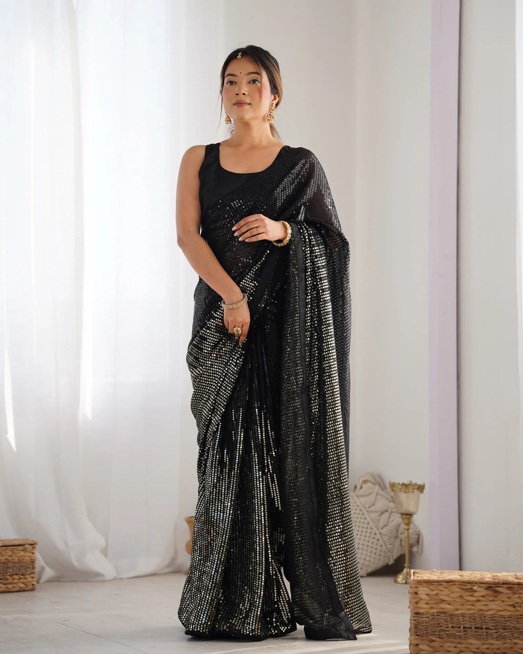 Full front view of model in black sequence embroidered saree