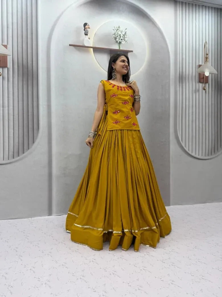 Model wearing mustard yellow rion cotton lehenga choli with mirror work jacket