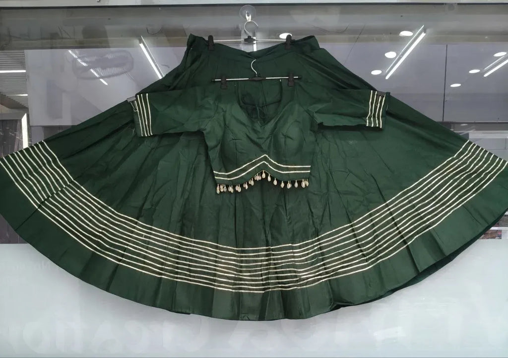 Dark green heavy cotton lehenga and blouse set displayed on hangers