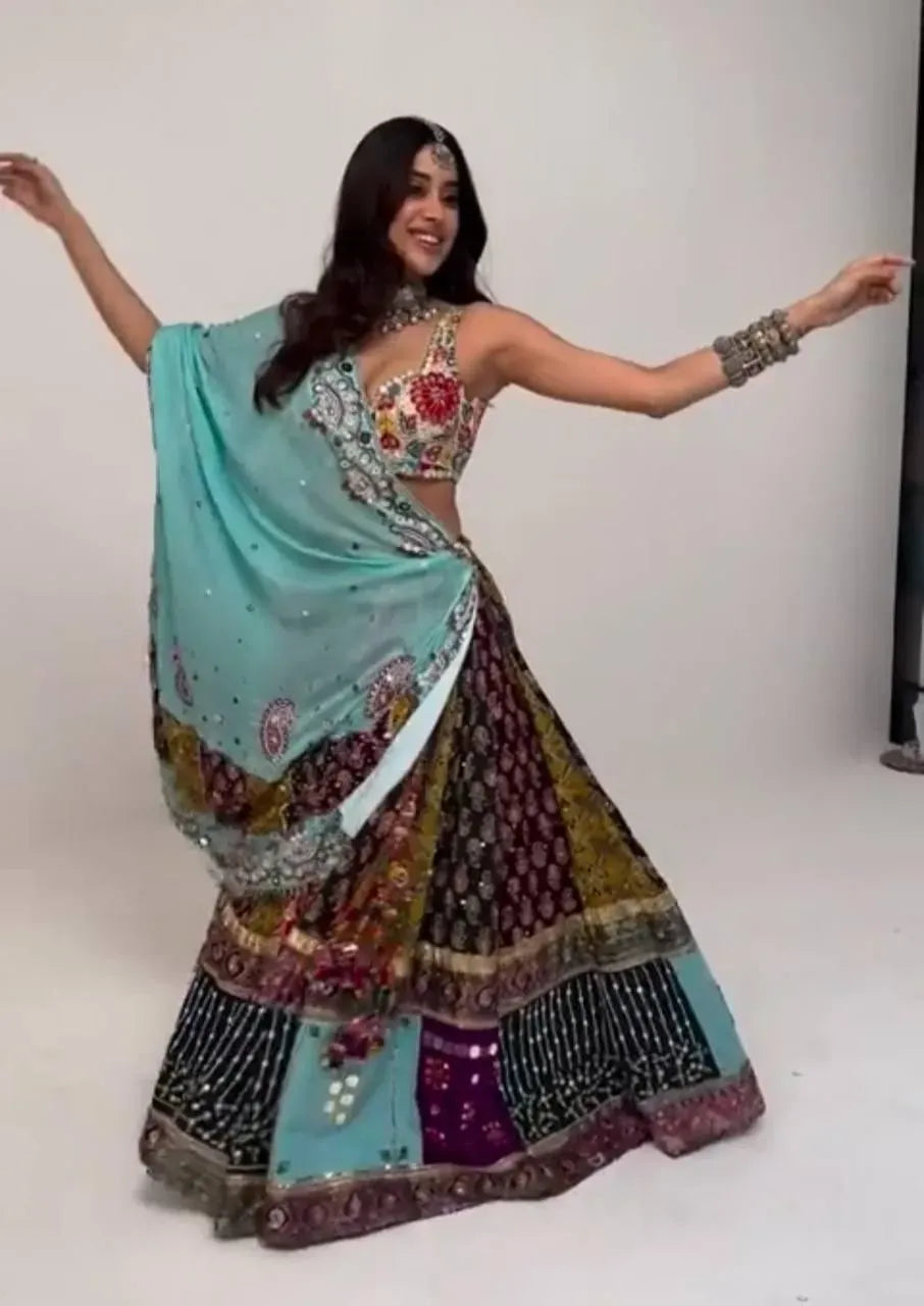 Smiling model in multi-color printed lehenga choli with mint dupatta