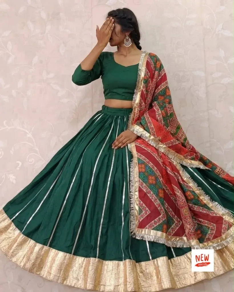 Model wearing dark green rayon cotton skirt and blouse set with colorful printed dupatta