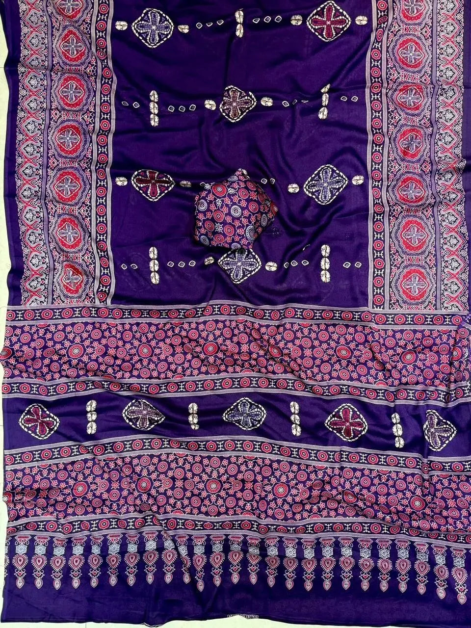 Purple moss saree laid flat showing detailed border and pallu design