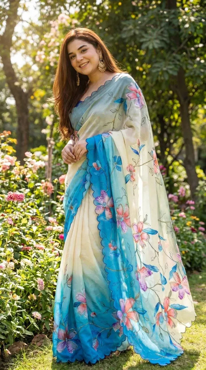 Model wearing white and blue digital print georgette saree in garden