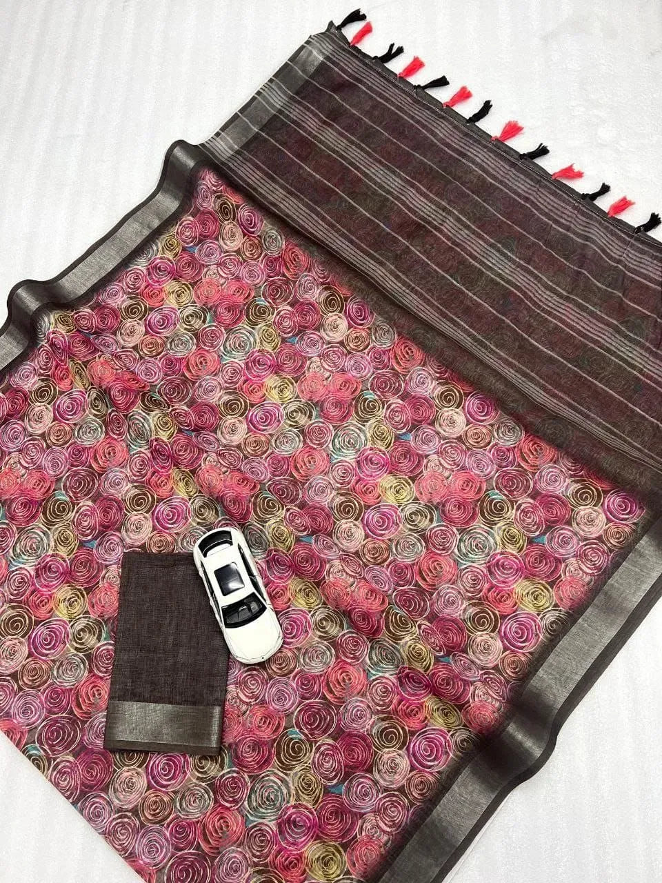 Pink floral digital print linen saree with dark contrasting pallu and tassels