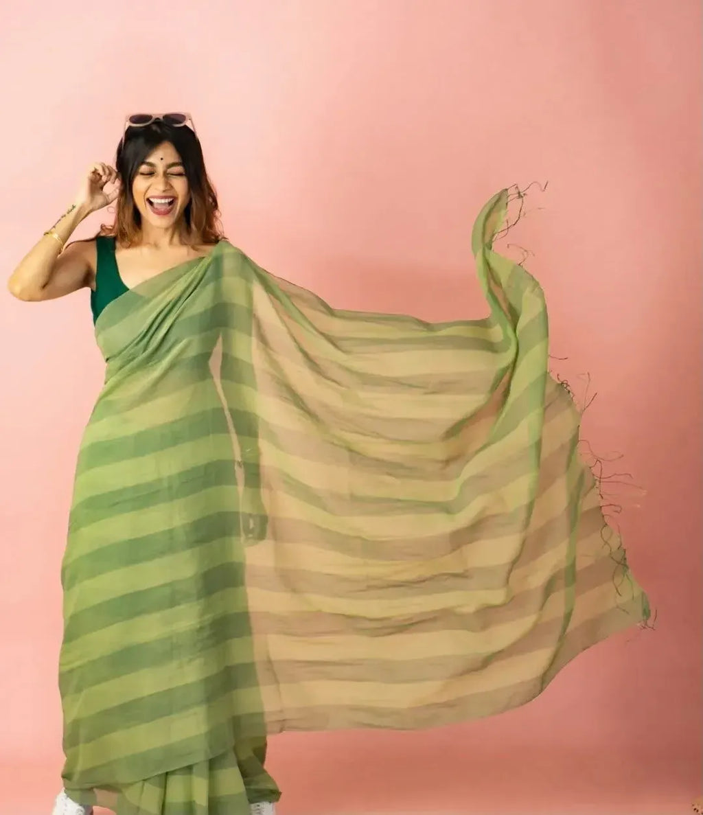 Model in green striped linen cotton saree with flowing palla
