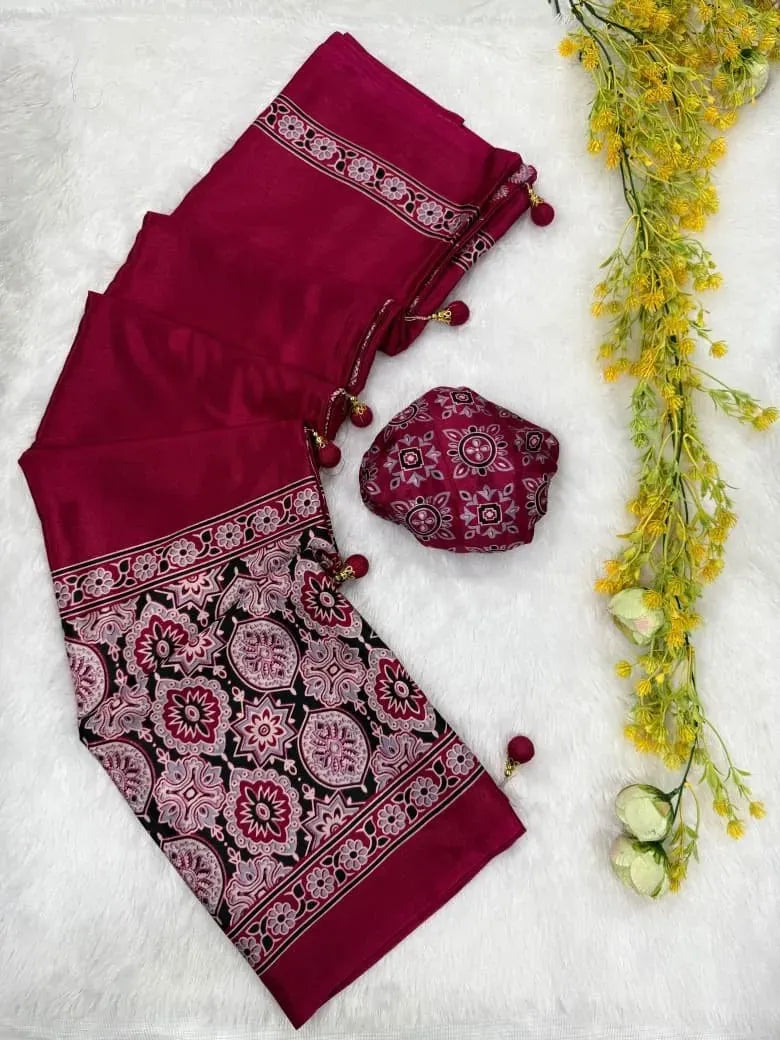 Folded rani pink gajji crepe silk saree with ajrakh print border and latkans