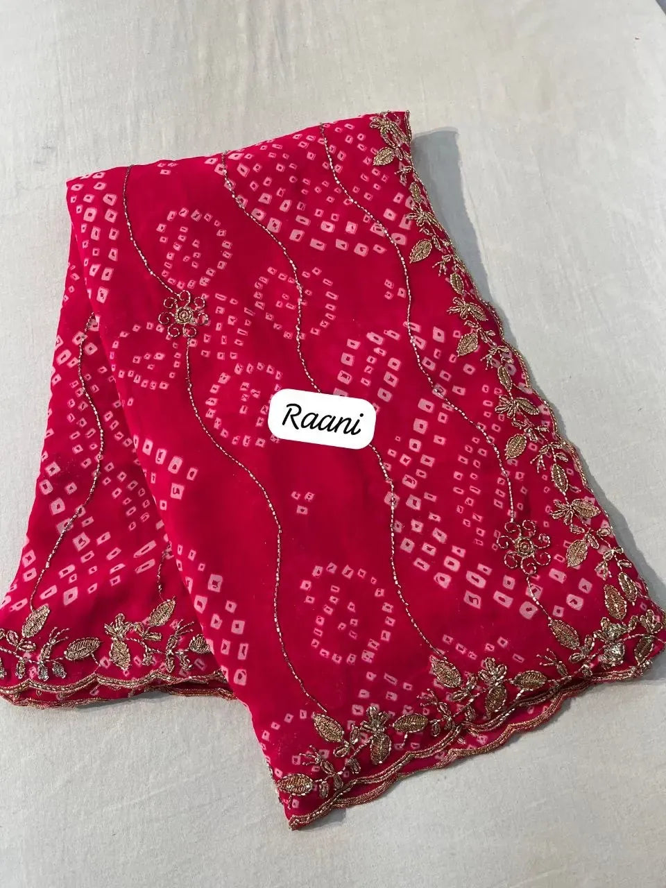 Raani pink georgette bandhej saree with heavy golden zari embroidery and scalloped border