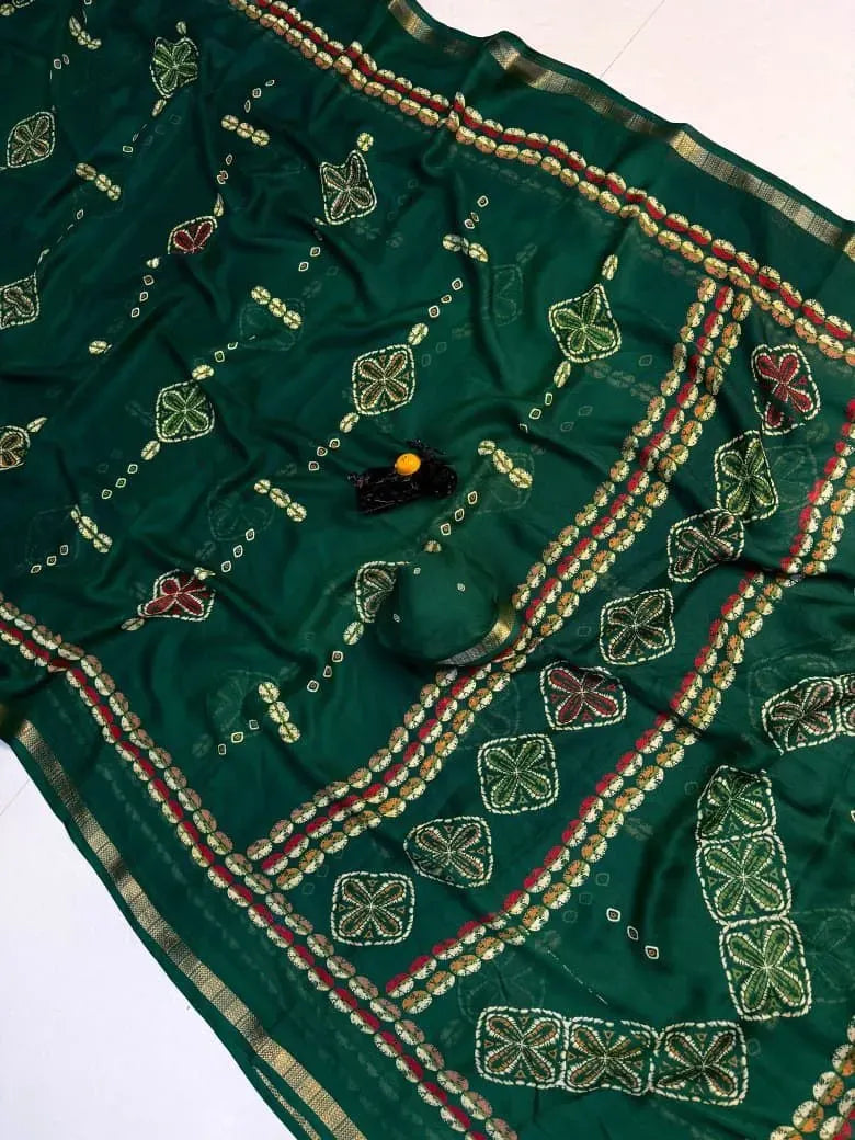Green georgette saree flat lay with traditional print and gold border