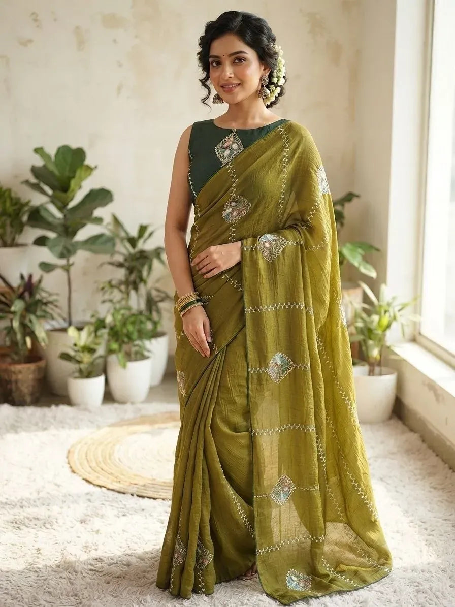 Model wearing olive green jordan crush saree with heavy bhungli work