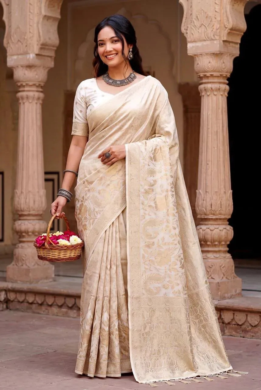 Model wearing white and gold jacquard weave saree with basket of flowers