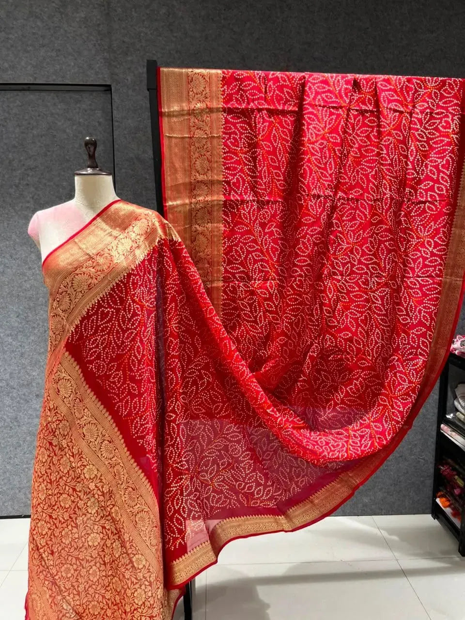 Red Kanjivaram Bandhani saree with heavy golden zari border on mannequin