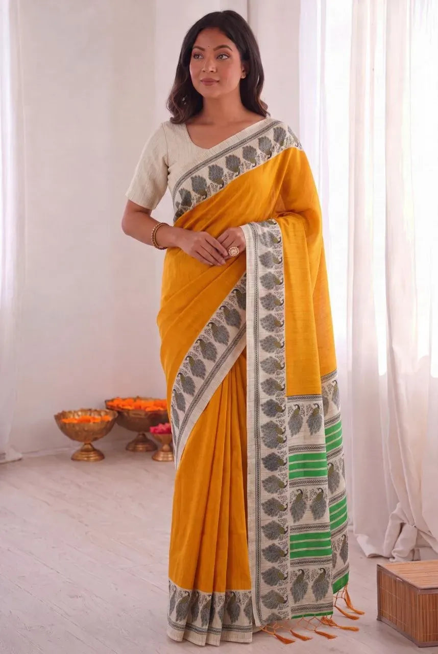 Yellow khadi cotton saree with peacock print border on model