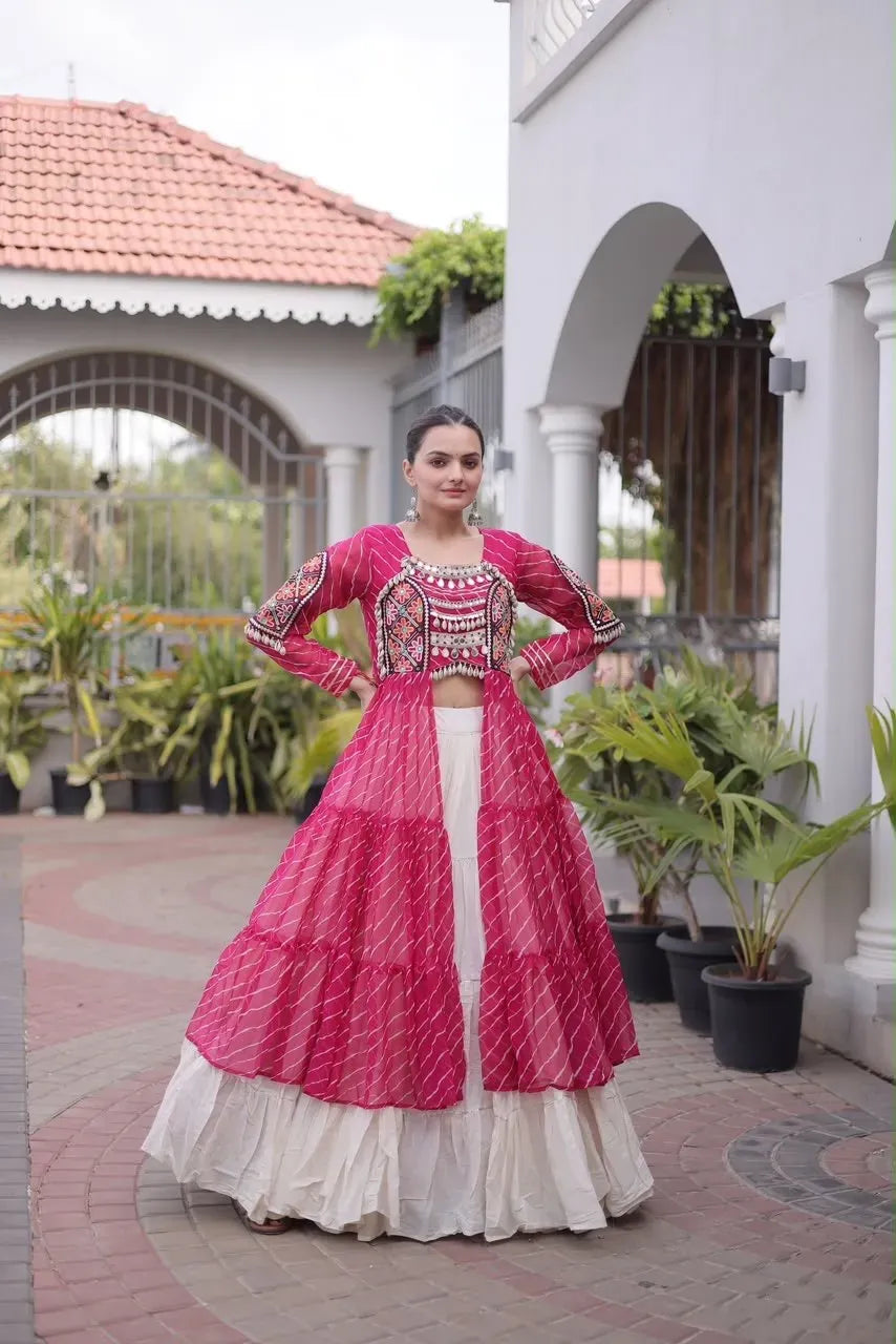 Model posing in a magenta pink laheriya long kurti with Kutchi patchwork and a white tiered cotton lehenga