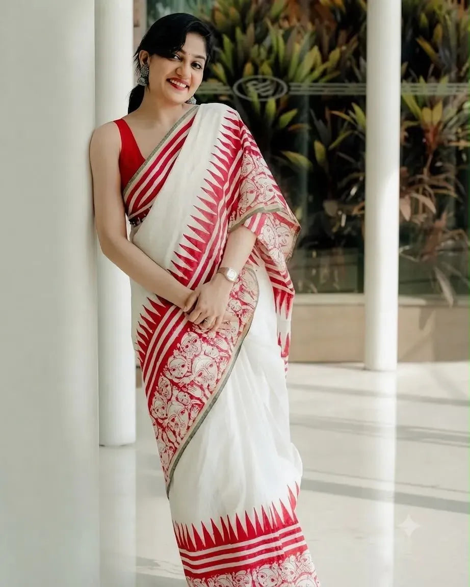 Model wearing white and red digital printed linen cotton saree leaning against pillar