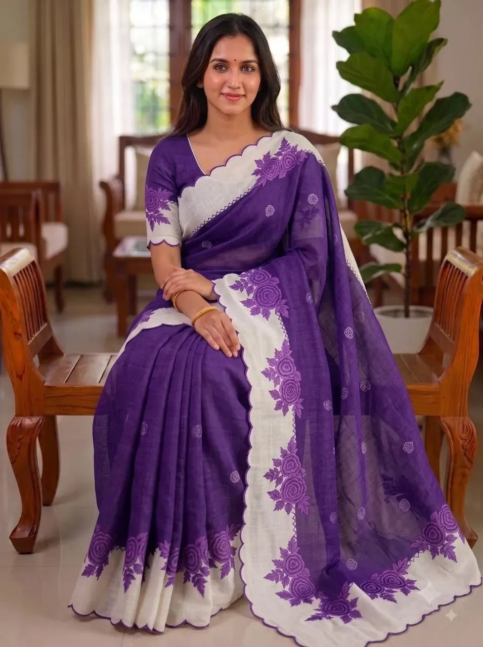 Model wearing purple plain linen saree with printed blouse and cut work