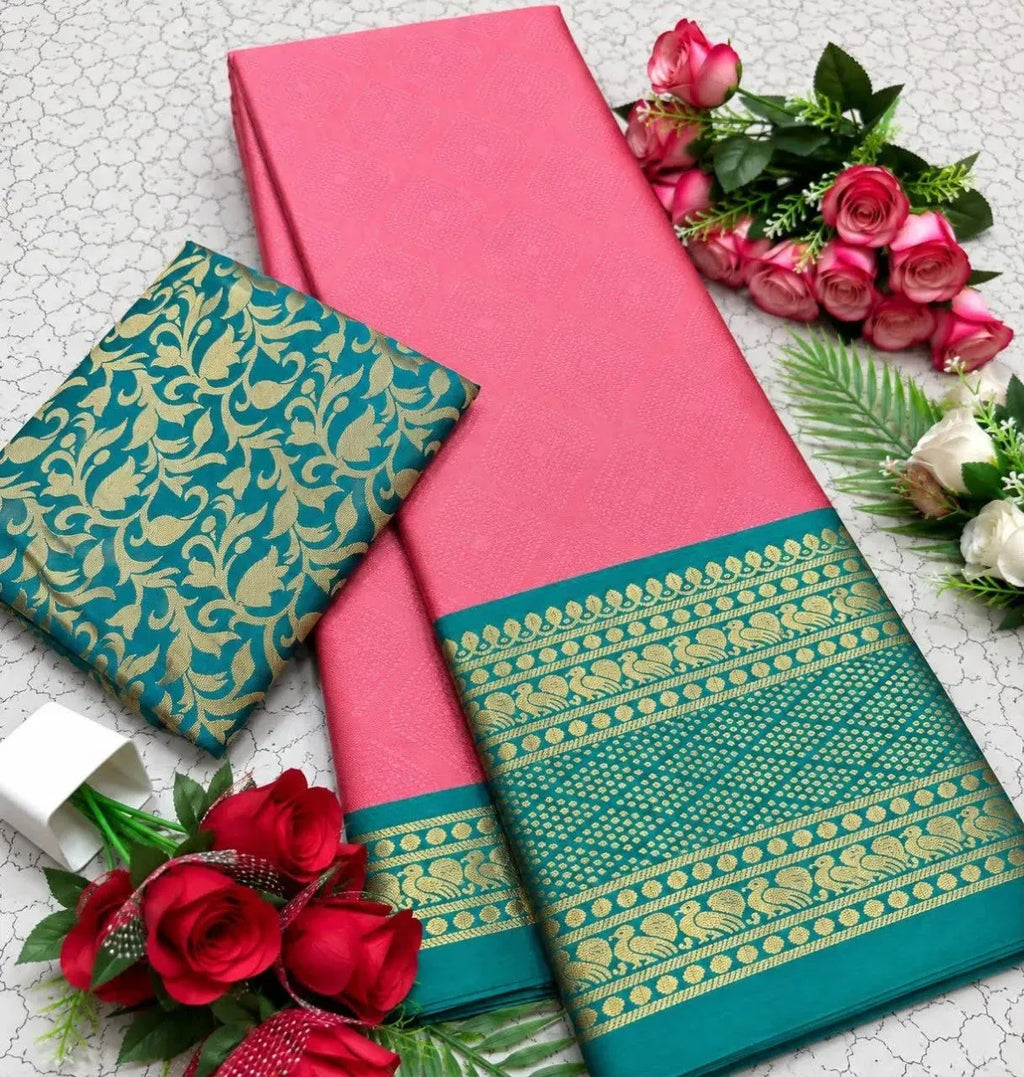 Pink mercerised copper silk saree with teal contrast border and folded blouse piece