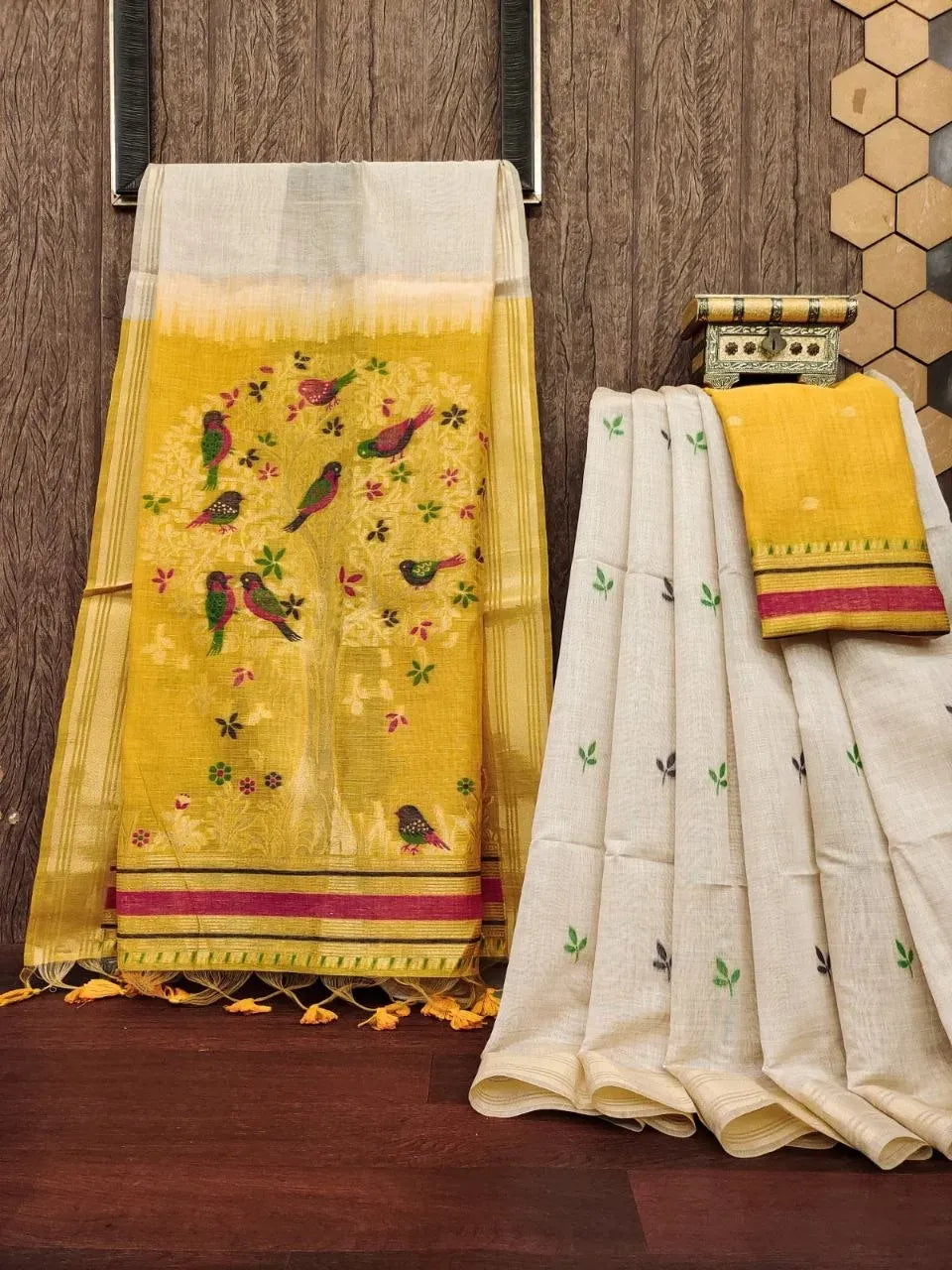 Soft white muga cotton saree with yellow pallu featuring tree and bird motifs
