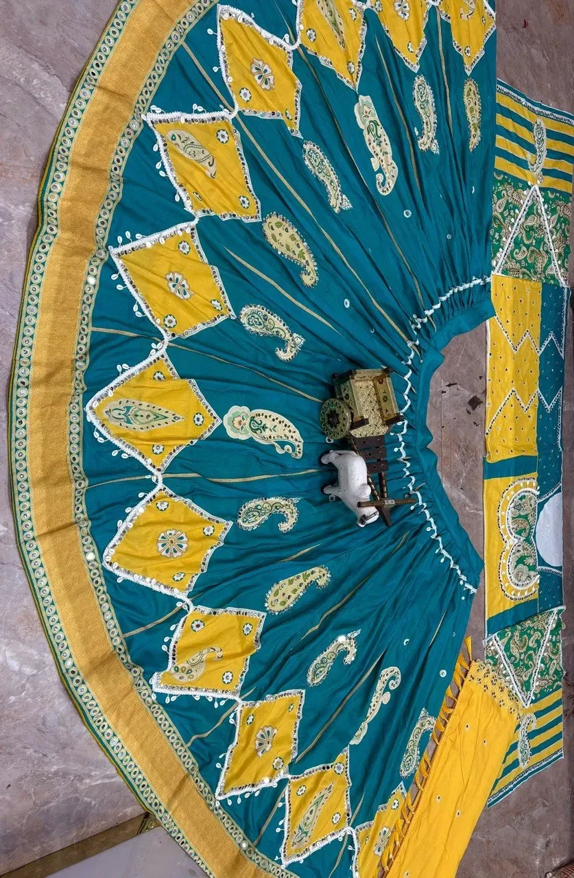 Teal and yellow muslin silk lehenga spread out showing 4 meter flare with mirror work
