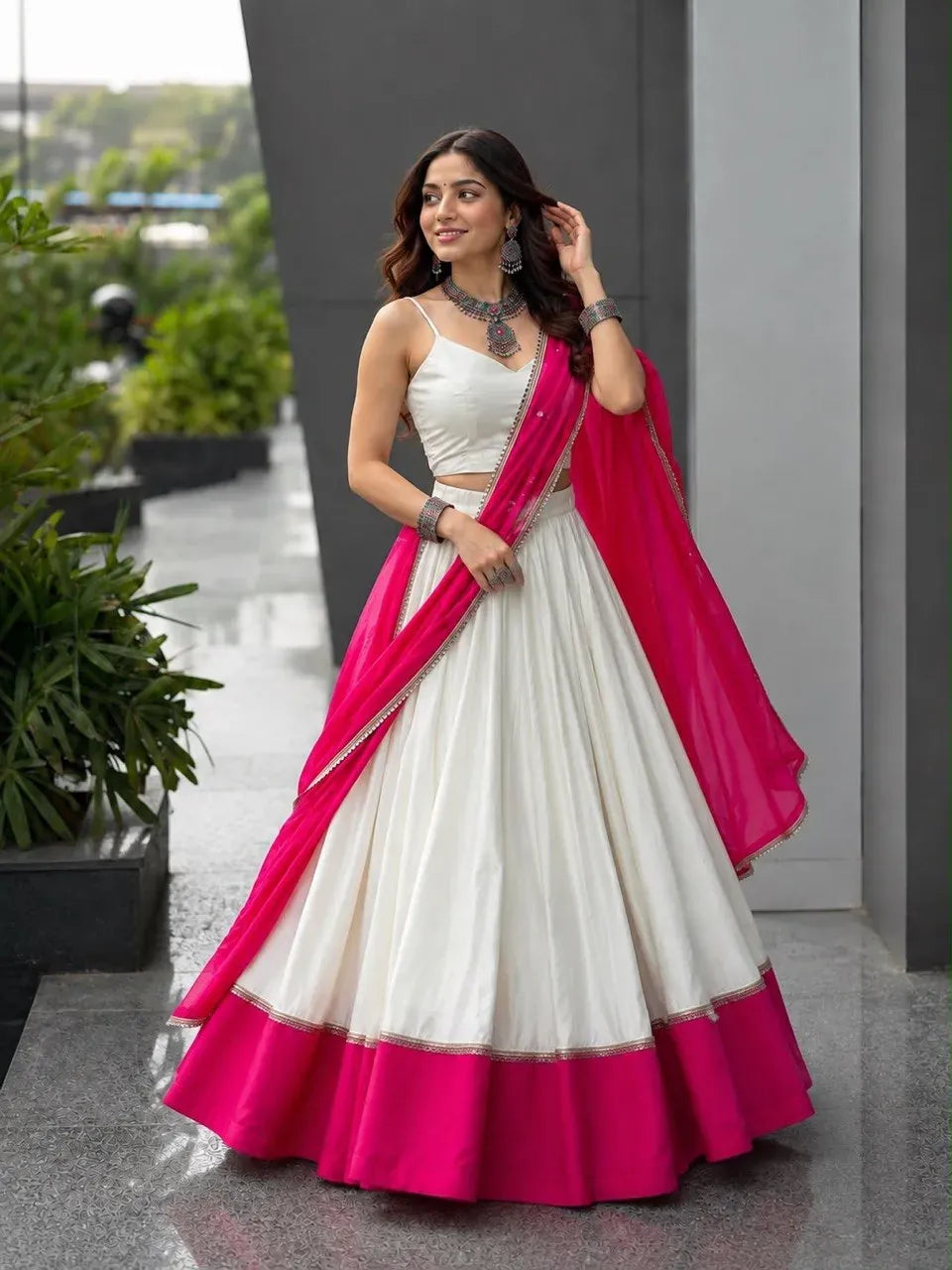 Model wearing white and pink cotton mirror work lehenga choli with georgette dupatta