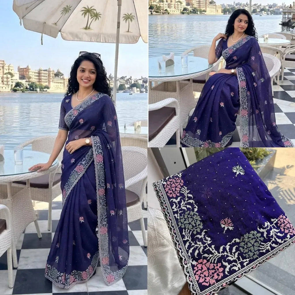 Model wearing dark blue embroidered party wear chiffon saree outdoors