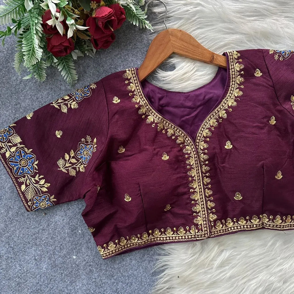 Wine pure silk blouse with intricate gold zari embroidery on hanger